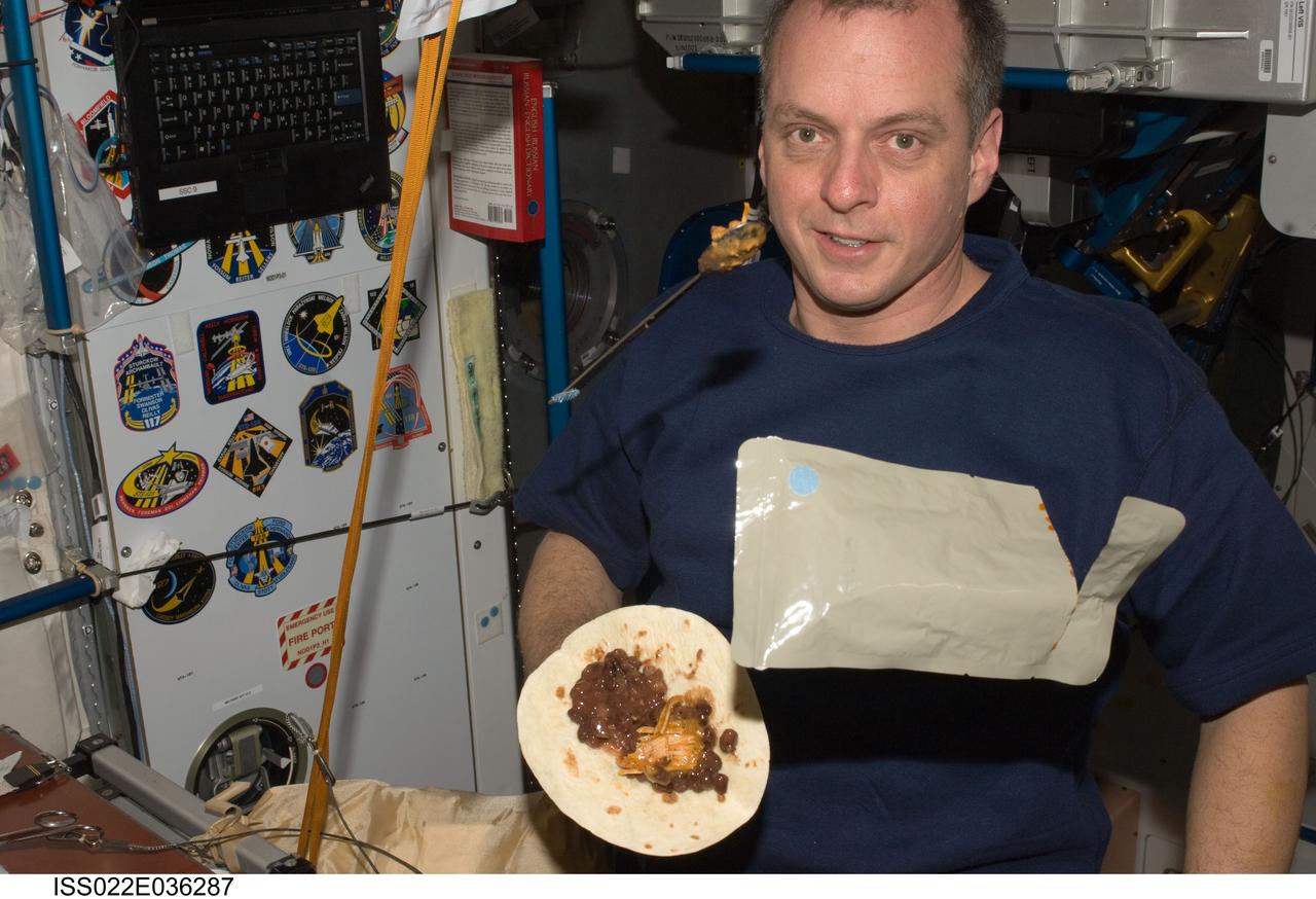 ISS022-E-036287 (21 Jan. 2010) --- NASA astronaut T.J. Creamer, Expedition 22 flight engineer, is pictured near food floating freely at the galley in the Unity node of the International Space Station.