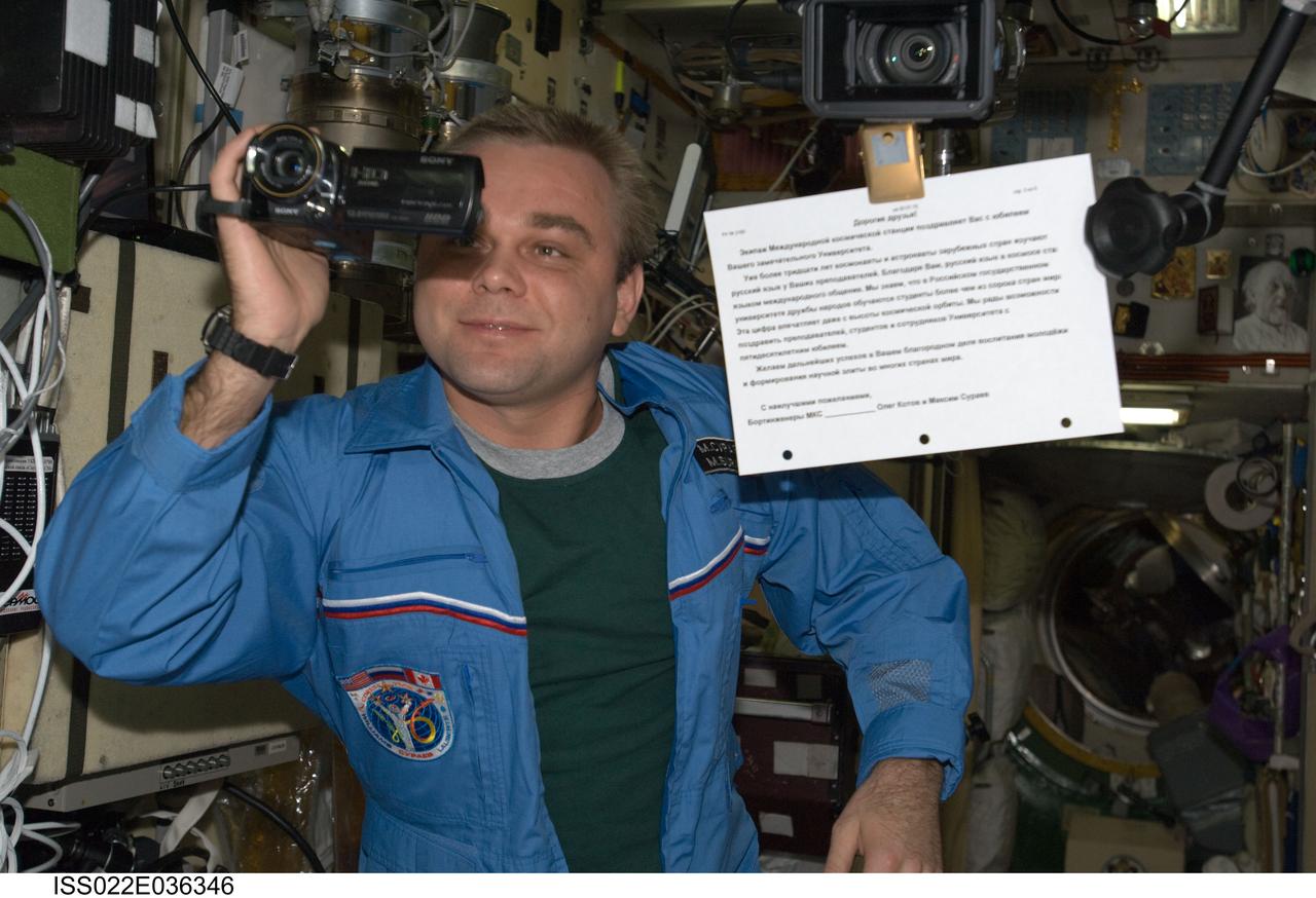ISS022-E-036346 (20 Jan. 2010) --- Russian cosmonaut Maxim Suraev, Expedition 22 flight engineer, uses a High Definition camcorder in the Zvezda Service Module of the International Space Station.
