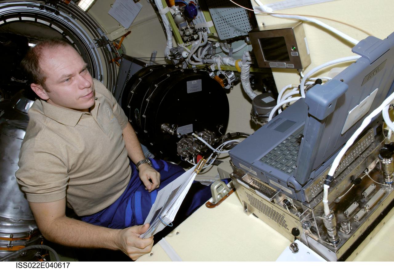 ISS022-E-040617 (28 Jan. 2010) --- Russian cosmonaut Oleg Kotov, Expedition 22 flight engineer, is pictured while working with the Plasma Crystal-3 experiment in the Zvezda Service Module of the International Space Station.