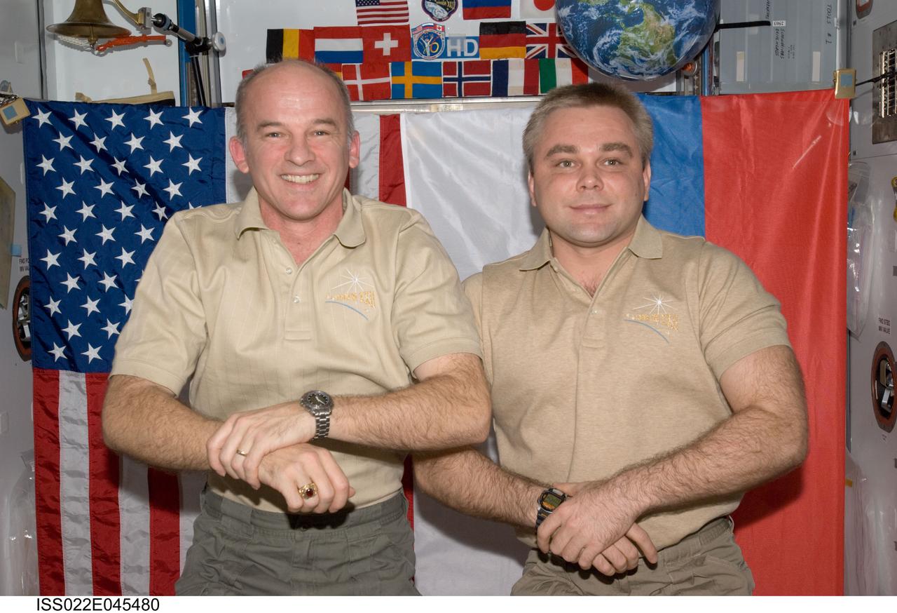 ISS022-E-045480 (31 Jan. 2010) --- NASA astronaut Jeffrey Williams (left), Expedition 22 commander; and Russian cosmonaut Maxim Suraev, flight engineer, pose for a photo in the Harmony node of the International Space Station.