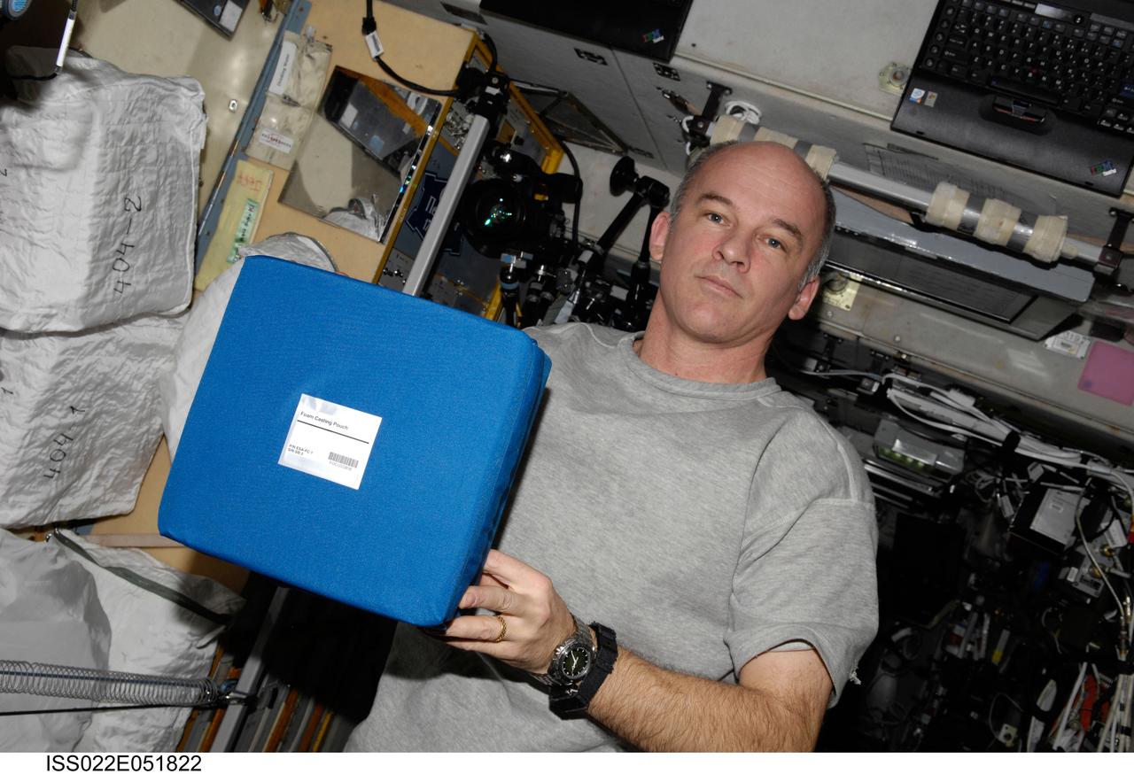 ISS022-E-051822 (5 Feb. 2010) --- NASA astronaut Jeffrey Williams, Expedition 22 commander, is pictured with a stowage container in the Zvezda Service Module of the International Space Station.