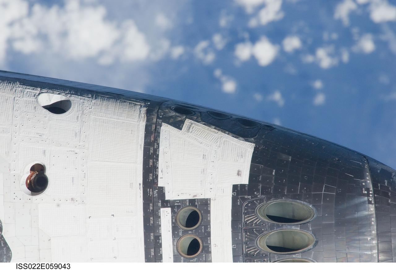 ISS022-E-059043 (9 Feb. 2010) --- This nadir image showing mostly the port side of space shuttle Endeavour's crew cabin was photographed with a digital camera?s 800mm lens by one of the Expedition 22 crew members aboard the International Space Station. The two spacecraft were in the midst of rendezvous operations, which included a back-flip by the shuttle.