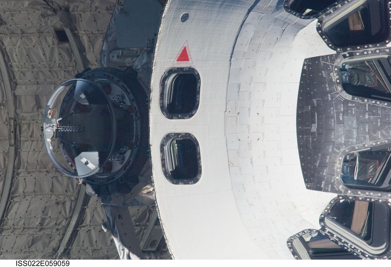 ISS022-E-059059 (9 Feb. 2010) --- This 800mm image showing the top of space shuttle Endeavour's crew cabin and the docking mechanism was photographed by one of the Expedition 22 crew members aboard the International Space Station. The two spacecraft were in the midst of rendezvous operations, which included a back-flip by the shuttle for the purposes of inspecting and photographing it from a number of angles.