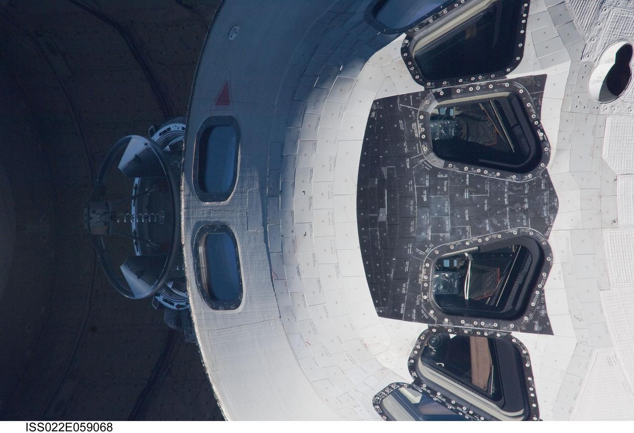 ISS022-E-059068 (9 Feb. 2010) --- This 800mm image showing a head-on view of space shuttle Endeavour's crew cabin, was photographed by one of the Expedition 22 crew members aboard the International Space Station. The two spacecraft were in the midst of rendezvous operations, which included a back-flip by the shuttle for the purposes of inspecting and photographing it from a number of angles.