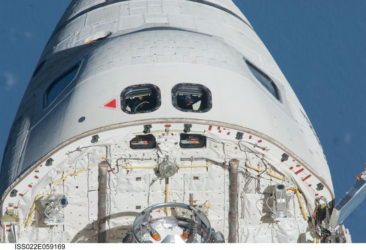 ISS022-E-059169 (9 Feb. 2010) --- This image, showing the top of space shuttle Endeavour's crew cabin, its firewall and part of the docking mechanism in the cargo bay, was photographed by one of the Expedition 22 crew members aboard the International Space Station. The two spacecraft were in the midst of rendezvous operations, which included a back-flip by the shuttle for the purposes of inspecting and photographing it from a number of angles.