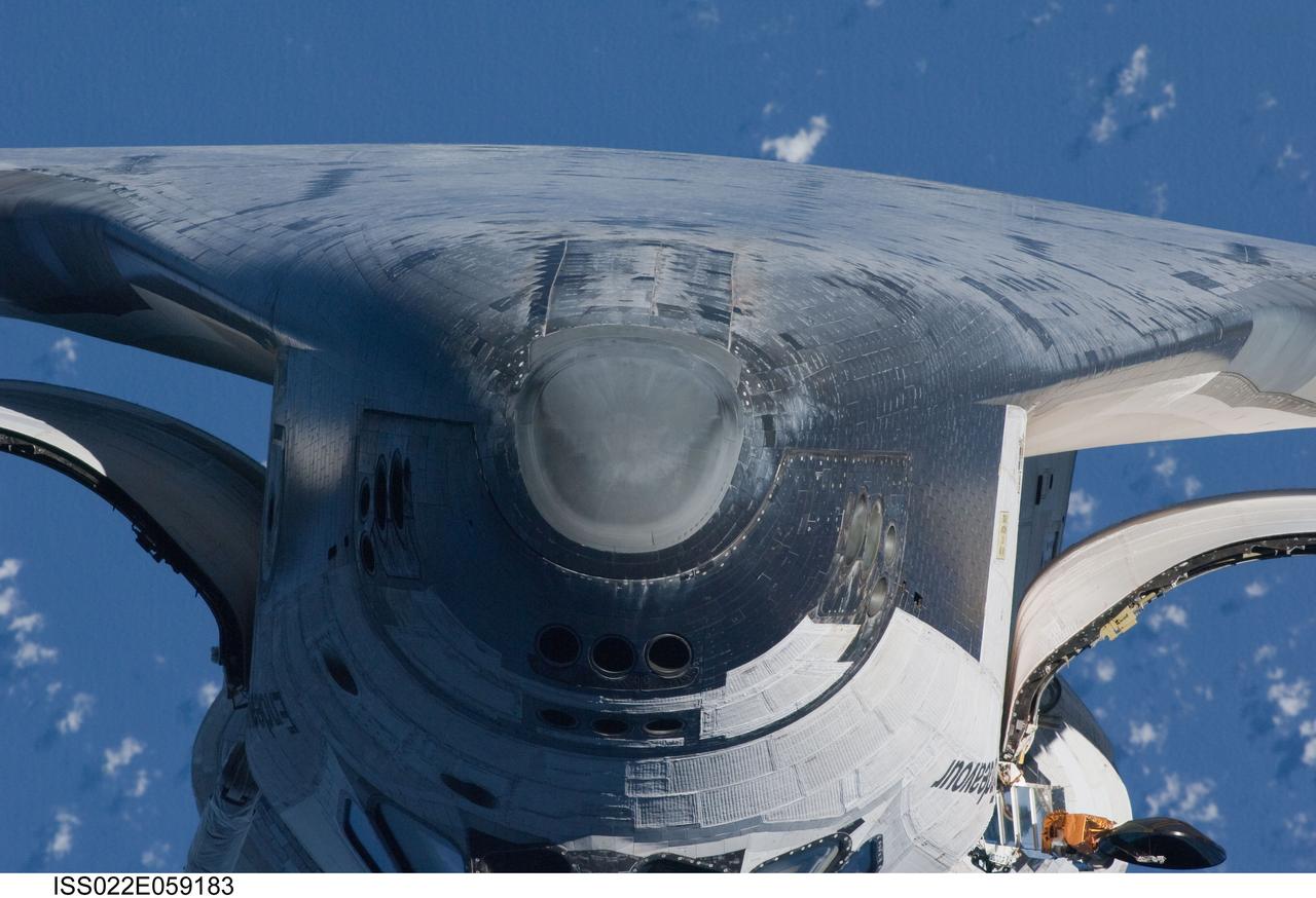 ISS022-E-059183 (9 Feb. 2010) --- This view of the underside of the crew cabin of the space shuttle Endeavour was provided by an Expedition 22 crew member during a survey of the approaching STS-130 crew to the International Space Station. As part of the survey and part of every mission's activities, Endeavour performed a back-flip for the rendezvous pitch maneuver (RPM). The image was photographed with a digital still camera, using a 400mm lens at a distance of about 600 feet (180 meters).
