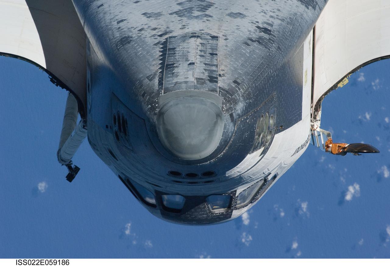 ISS022-E-059186 (9 Feb. 2010) --- This view of the underside of the crew cabin of the space shuttle Endeavour was provided by an Expedition 22 crew member during a survey of the approaching STS-130 crew to the International Space Station. As part of the survey and part of every mission's activities, Endeavour performed a back-flip for the rendezvous pitch maneuver (RPM). The image was photographed with a digital still camera, using a 400mm lens at a distance of about 600 feet (180 meters).