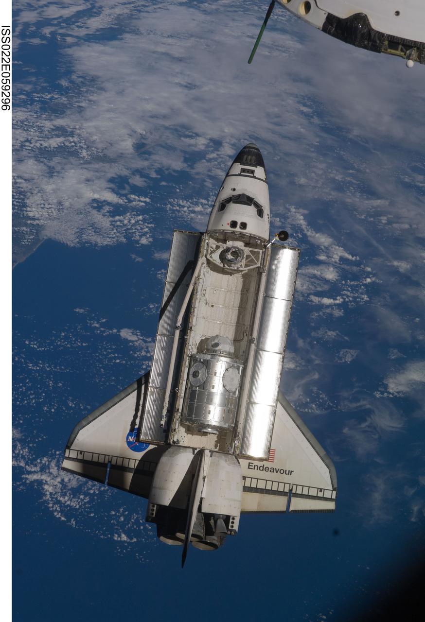 ISS022-E-059296 (9 Feb. 2010) --- Backdropped by a blue and white part of Earth, space shuttle Endeavour is featured in this image photographed by an Expedition 22 crew member as the shuttle approaches the International Space Station during STS-130 rendezvous and docking operations. Docking occurred at 11:06 p.m. (CST) on Feb. 9, 2010.