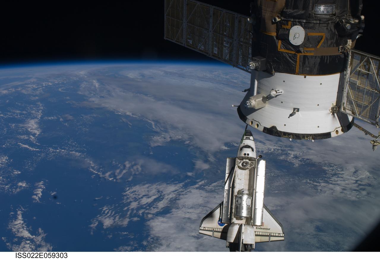 ISS022-E-059303 (9 Feb. 2010) --- Backdropped by a blue and white part of Earth, space shuttle Endeavour is featured in this image photographed by an Expedition 22 crew member as the shuttle approaches the International Space Station during STS-130 rendezvous and docking operations. Docking occurred at 11:06 p.m. (CST) on Feb. 9, 2010. A docked Russian spacecraft is at upper right.