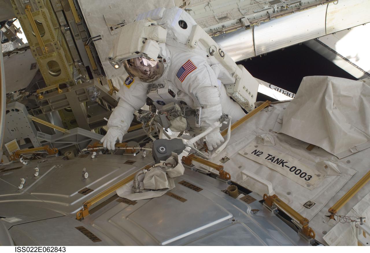 ISS022-E-062843 (11 Feb. 2010) --- NASA astronaut Nicholas Patrick, STS-130 mission specialist, participates in the mission's first session of extravehicular activity (EVA) as construction and maintenance continue on the International Space Station. During the 6-hour, 32-minute spacewalk, Patrick and astronaut Robert Behnken (out of frame), mission specialist, relocated a temporary platform from the Special Purpose Dexterous Manipulator, or Dextre, to the station?s truss structure and installed two handles on the robot. Once Tranquility was structurally mated to Unity, the spacewalkers connected heater and data cables that will integrate the new module with the rest of the station?s systems. They also pre-positioned insulation blankets and ammonia hoses that will be used to connect Tranquility to the station?s cooling radiators during the mission?s second spacewalk.