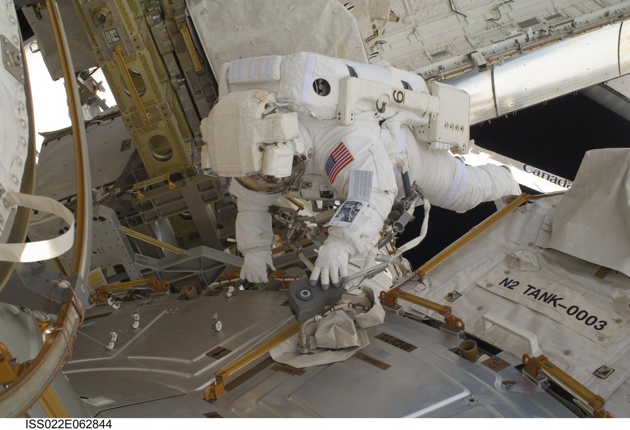 ISS022-E-062844 (11 Feb. 2010) --- NASA astronaut Nicholas Patrick, STS-130 mission specialist, participates in the mission's first session of extravehicular activity (EVA) as construction and maintenance continue on the International Space Station. During the 6-hour, 32-minute spacewalk, Patrick and astronaut Robert Behnken (out of frame), mission specialist, relocated a temporary platform from the Special Purpose Dexterous Manipulator, or Dextre, to the station?s truss structure and installed two handles on the robot. Once Tranquility was structurally mated to Unity, the spacewalkers connected heater and data cables that will integrate the new module with the rest of the station?s systems. They also pre-positioned insulation blankets and ammonia hoses that will be used to connect Tranquility to the station?s cooling radiators during the mission?s second spacewalk.