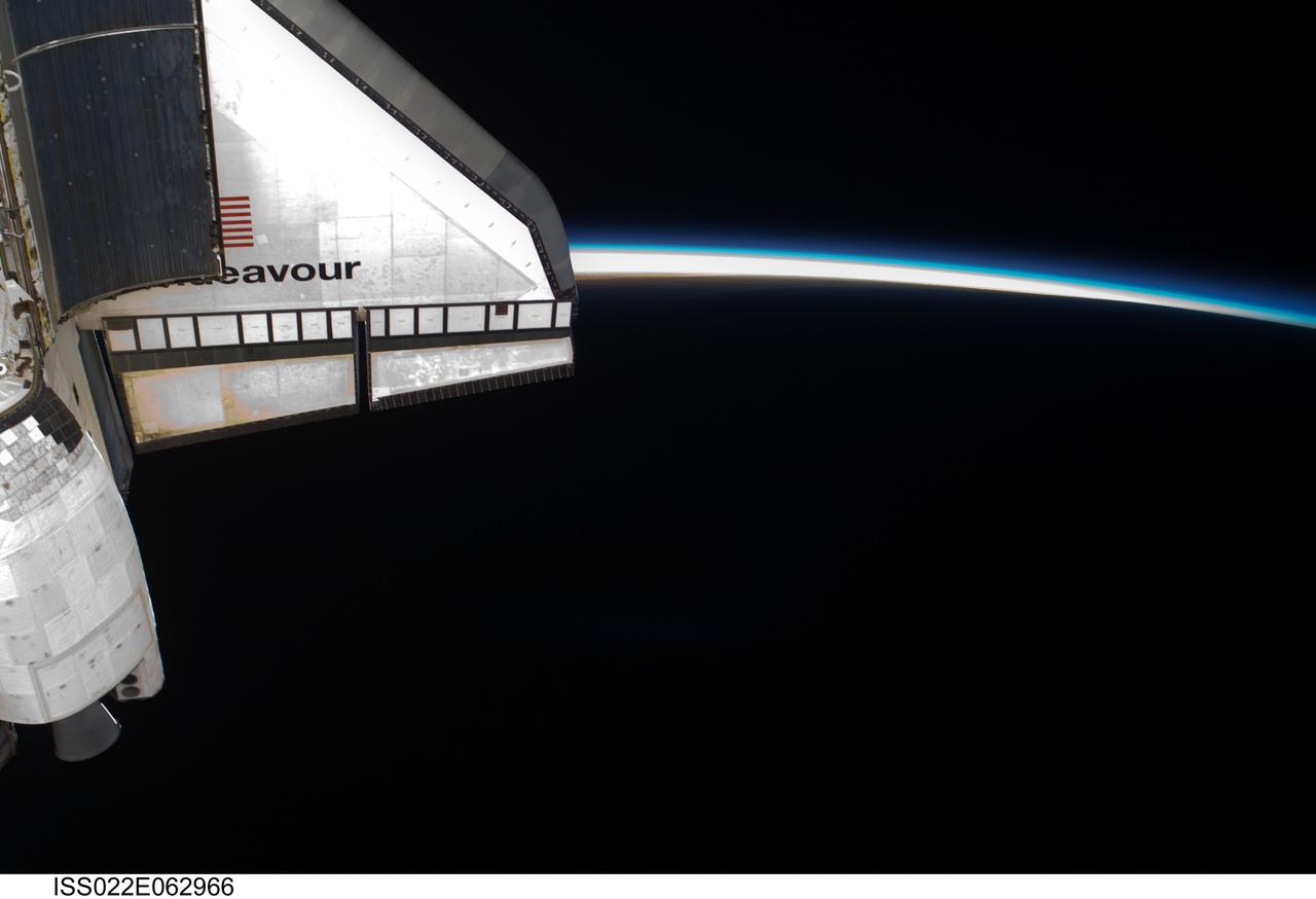 ISS022-E-062966 (11 Feb. 2010) --- Intersecting the thin line of Earth?s atmosphere, space shuttle Endeavour?s starboard wing is featured in this image photographed by an Expedition 22 crew member while Endeavour remains docked with the International Space Station.