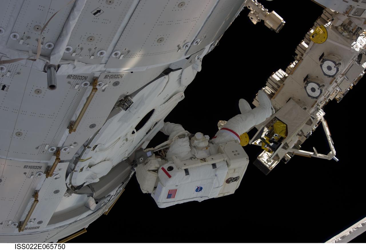 ISS022-E-065750 (14 Feb. 2010) --- NASA astronaut Robert Behnken, STS-130 mission specialist, participates in the mission?s second session of extravehicular activity (EVA) as construction and maintenance continue on the International Space Station. During the five-hour, 54-minute spacewalk, Behnken and astronaut Nicholas Patrick (out of frame), mission specialist, connected two ammonia coolant loops, installed thermal covers around the ammonia hoses, outfitted the Earth-facing port on the Tranquility node for the relocation of its Cupola, and installed handrails and a vent valve on the new module.