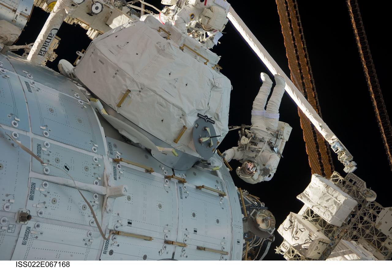 ISS022-E-067168 (17 Feb. 2010) --- NASA astronauts Robert Behnken (top) and Nicholas Patrick, both STS-130 mission specialists, participate in the mission?s third and final session of extravehicular activity (EVA) as construction and maintenance continue on the International Space Station. During the five-hour, 48-minute spacewalk, Behnken and Patrick completed all of their planned tasks, removing insulation blankets and removing launch restraint bolts from each of the Cupola?s seven windows.