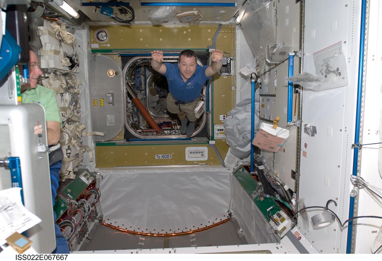 ISS022-E-067667 (14 Feb. 2010) --- NASA astronaut Nicholas Patrick, STS-130 mission specialist, floats freely in newly-installed Tranquility node of the International Space Station while space shuttle Endeavour remains docked with the station.