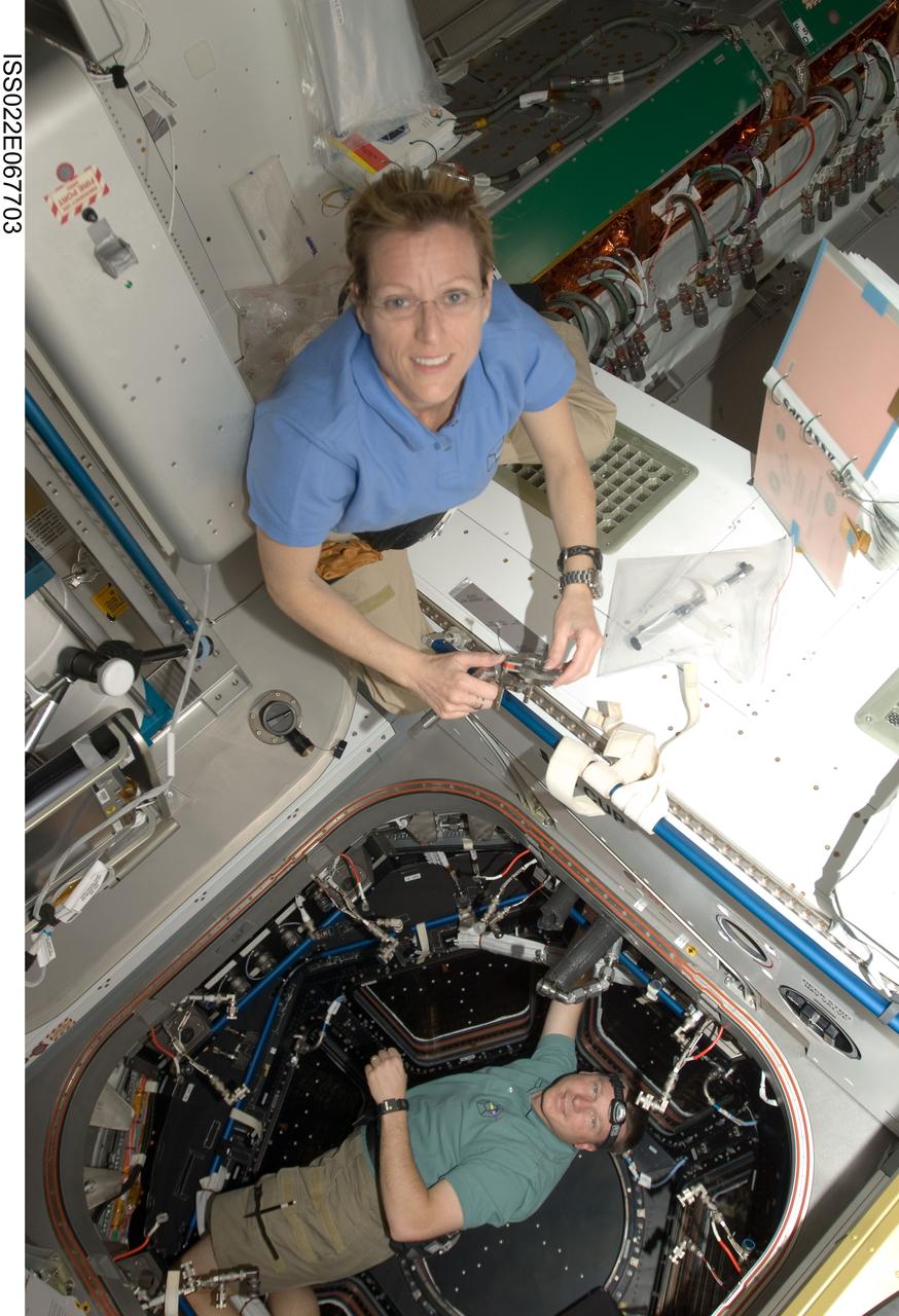 ISS022-E-067703 (17 Feb. 2010) --- NASA astronauts Kathryn Hire, STS-130 mission specialist; and Terry Virts, pilot, work in the Tranquility node and its Cupola of the International Space Station while space shuttle Endeavour remains docked with the station.