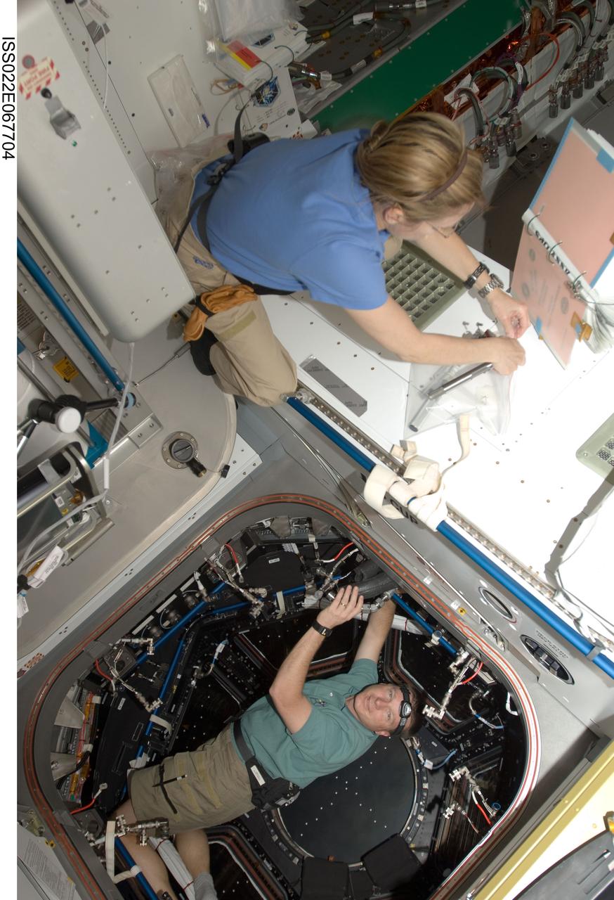ISS022-E-067704 (17 Feb. 2010) --- NASA astronauts Kathryn Hire, STS-130 mission specialist; and Terry Virts, pilot, work in the Tranquility node and its Cupola of the International Space Station while space shuttle Endeavour remains docked with the station.