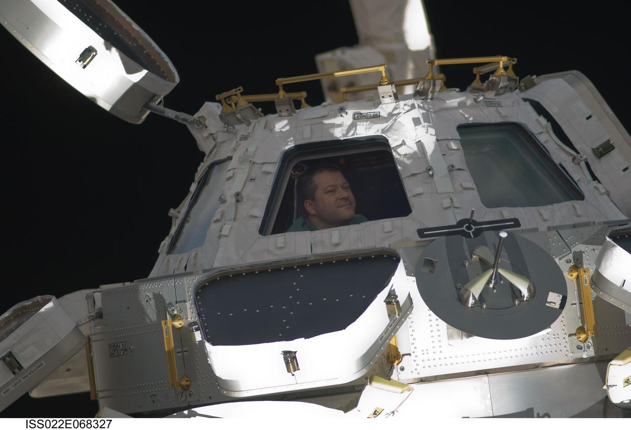 Patrick at the Cupola Module window during Joint Operations