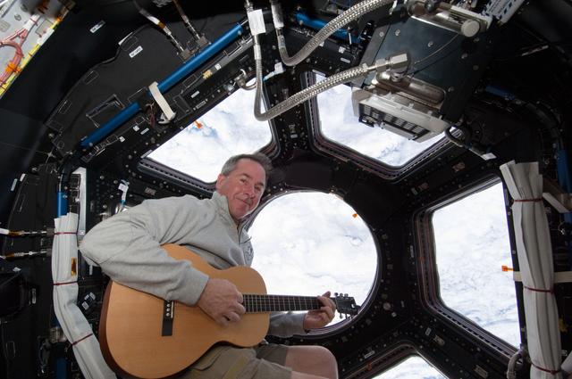 NASA image: Robinson plays guitar in the Cupola Module during Joint Operations