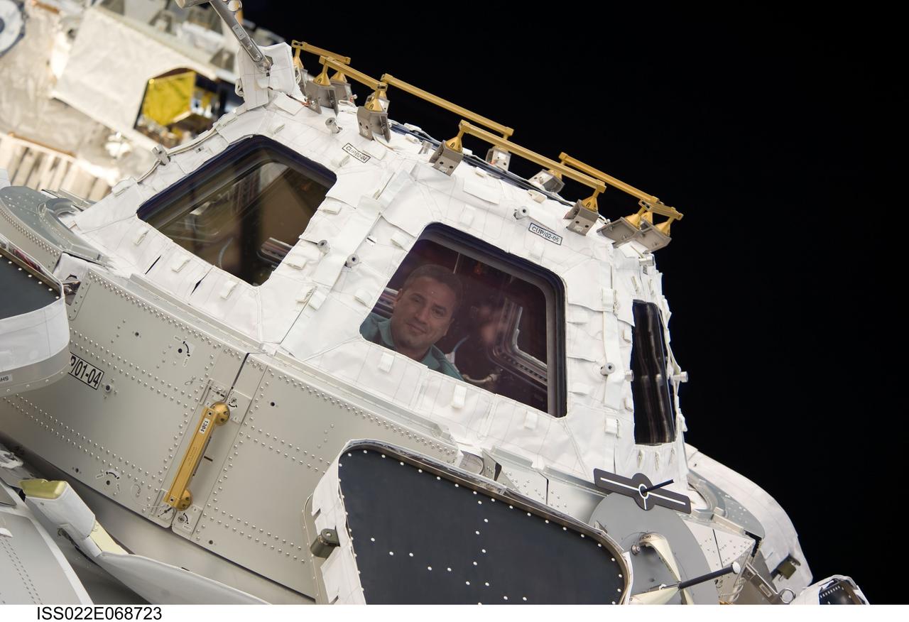 ISS022-E-068723 (19 Feb. 2010) --- NASA astronaut George Zamka, STS-130 commander, is pictured in a window of the newly-installed Cupola of the International Space Station while space shuttle Endeavour remains docked with the station.