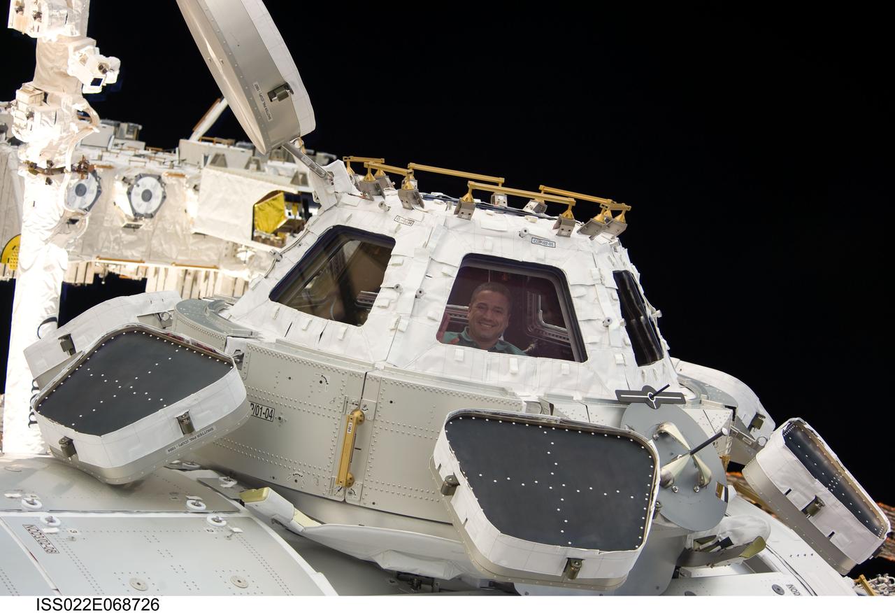 ISS022-E-068726 (19 Feb. 2010) --- NASA astronaut George Zamka, STS-130 commander, is pictured in a window of the newly-installed Cupola of the International Space Station while space shuttle Endeavour remains docked with the station.