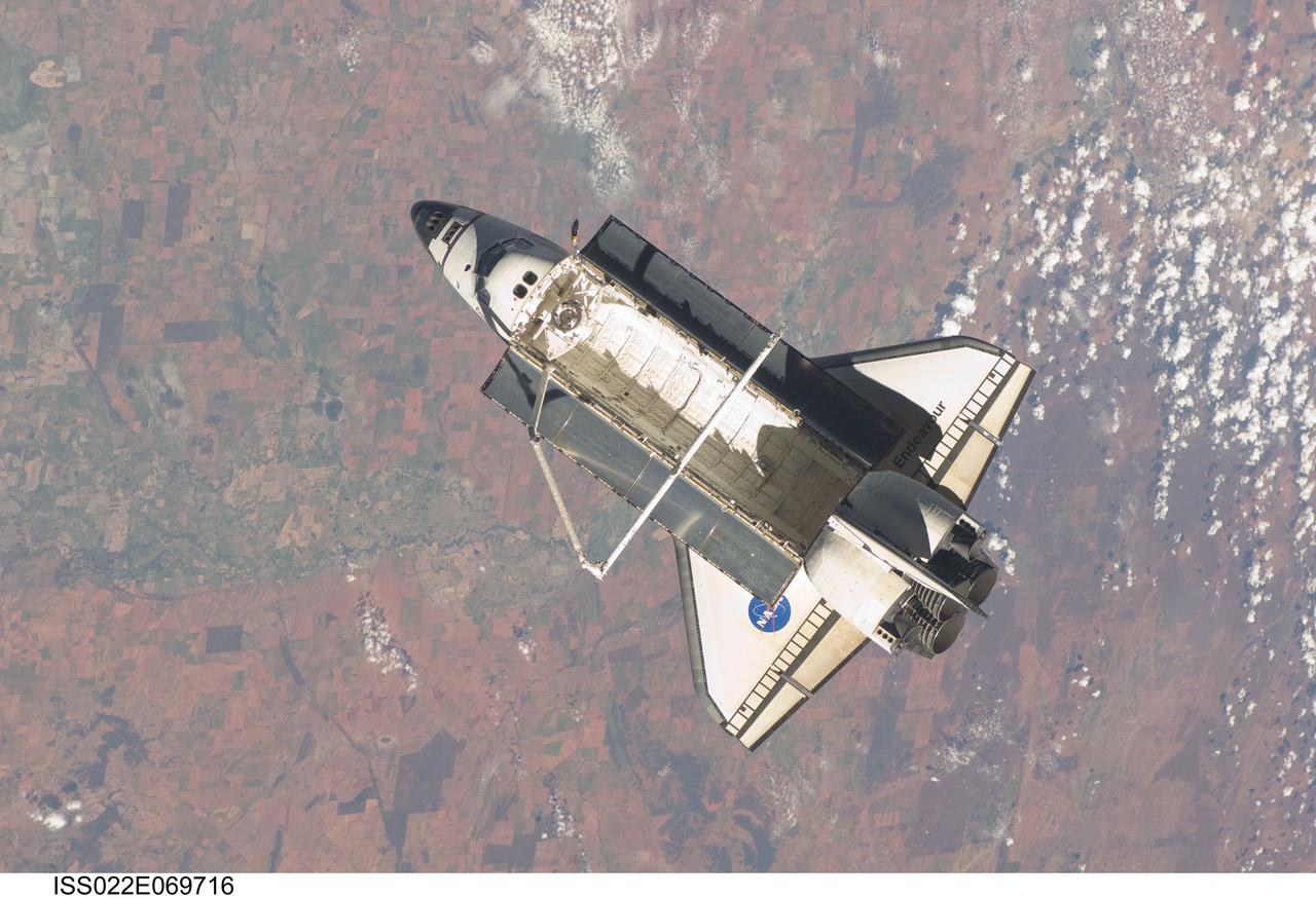ISS022-E-069716 (19 Feb. 2010) --- Backdropped by a colorful part of Earth, the space shuttle Endeavour is featured in this image photographed by an Expedition 22 crew member on the International Space Station soon after the shuttle and station began their post-undocking relative separation. Undocking of the two spacecraft occurred at 7:54 p.m. (EST) on Feb. 19, 2010.