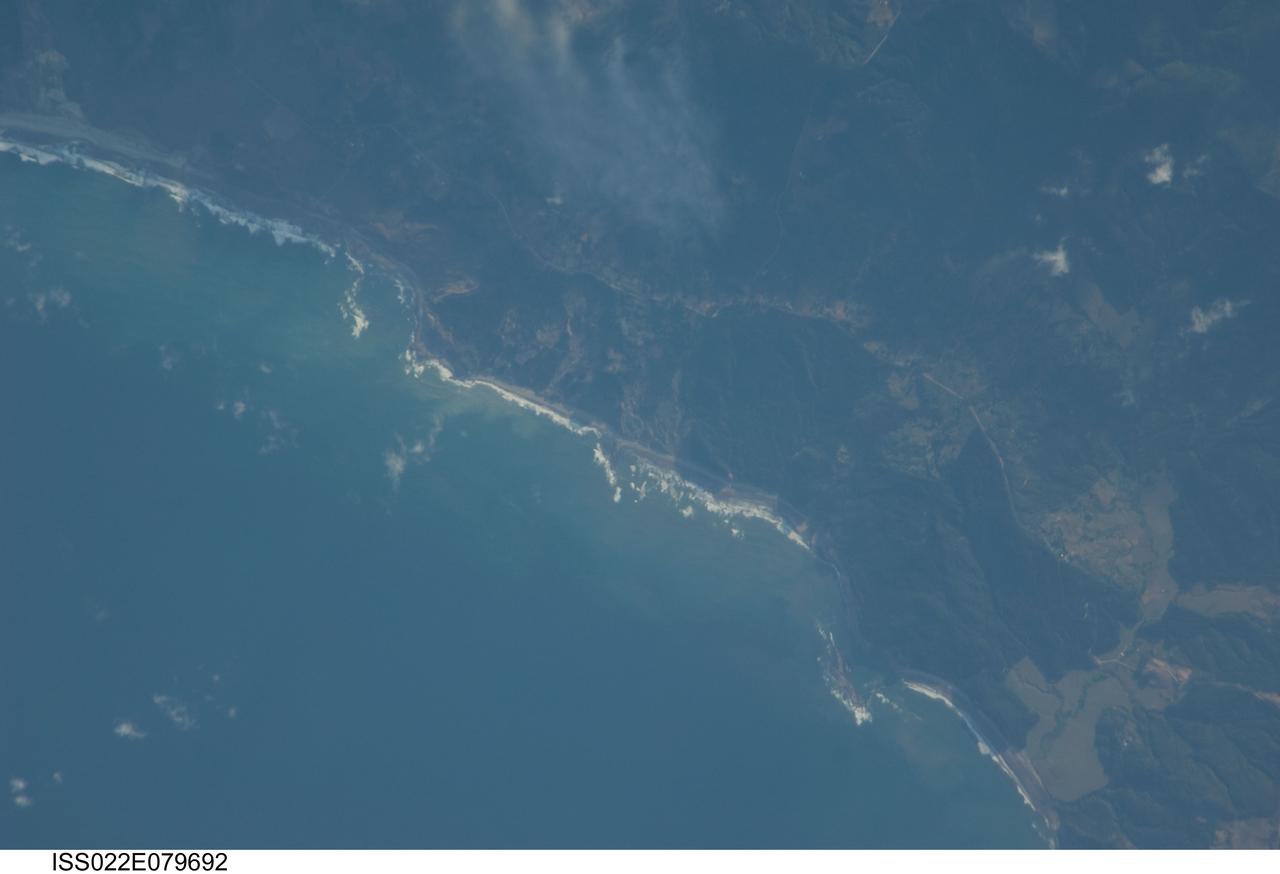 ISS022-E-079692 (3 March 2010) --- A rugged, isolated section of coast on Carnero Bay, about 60 miles south-southwest of Concepcion, Chile, is featured in this image photographed by an Expedition 22 crew member on the International Space Station. The area includes forested hills, a couple of highways, and perhaps some cleared pastureland. The narrow beach appears to be rocky with breakers and some sediment in the waters near-shore. The small coastal town of Labu (out of frame) lies less than ten miles to the south-southwest.
