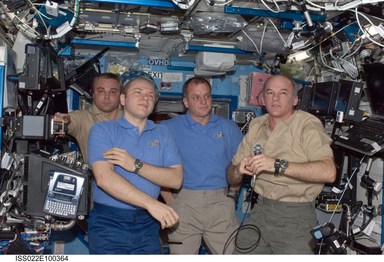 ISS022-E-100364 (17 March 2010) --- Crew members aboard the International Space Station are pictured in the Destiny laboratory during the ceremony of Changing-of-Command from Expedition 22 to Expedition 23. Pictured from the right are NASA astronauts Jeffrey Williams, Expedition 22 commander; and T.J. Creamer, Expedition 22/23 flight engineer; Russian cosmonauts Oleg Kotov, Expedition 22 flight engineer and Expedition 23 commander; and Maxim Suraev, Expedition 22 flight engineer. Not pictured is Japan Aerospace Exploration Agency (JAXA) astronaut Soichi Noguchi, Expedition 22/23 flight engineer.