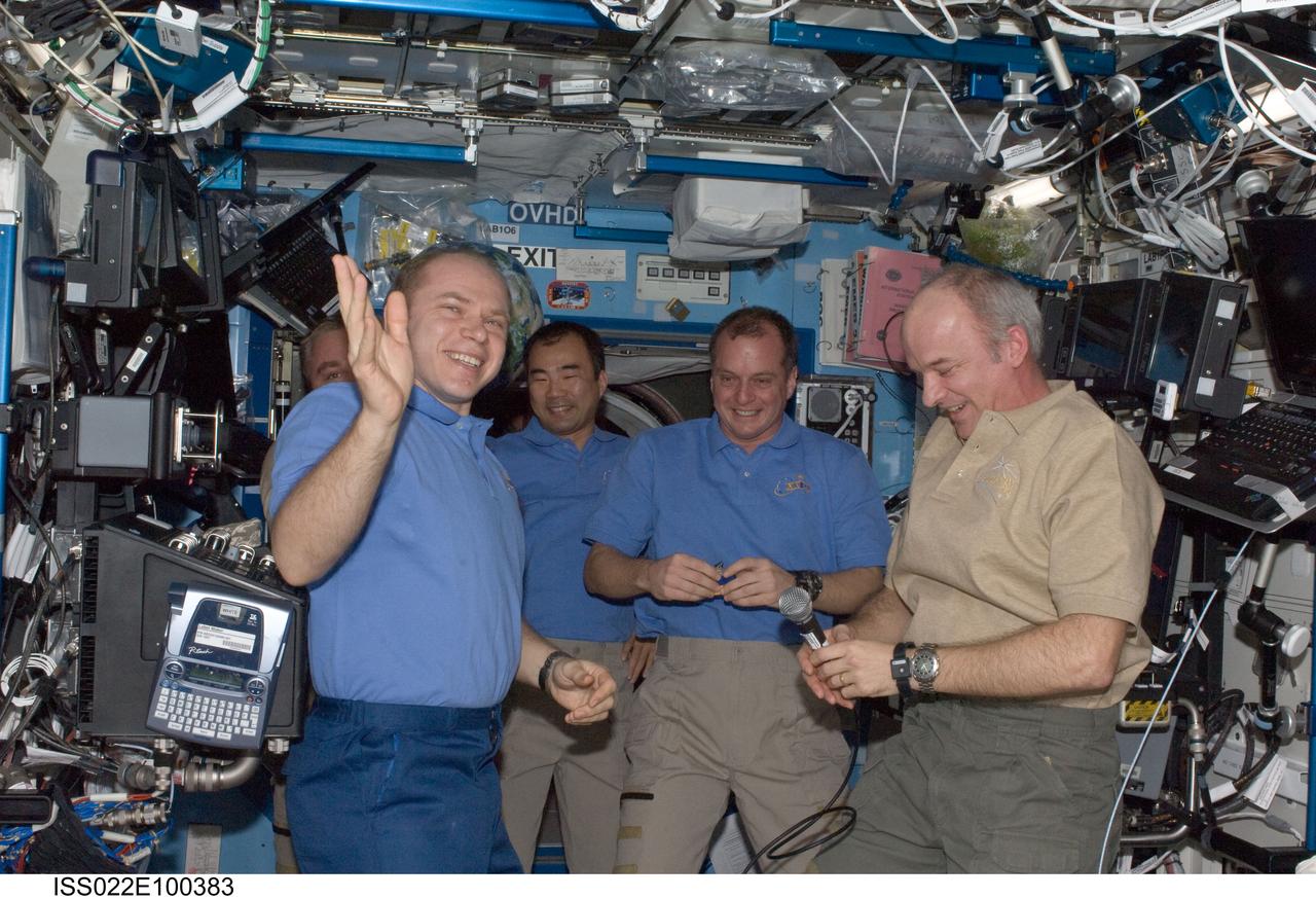 ISS022-E-100383 (17 March 2010) --- Crew members aboard the International Space Station are pictured in the Destiny laboratory during the ceremony of Changing-of-Command from Expedition 22 to Expedition 23. Pictured are NASA astronauts Jeffrey Williams (right, holding microphone), Expedition 22 commander; and T.J. Creamer (second right), Expedition 22/23 flight engineer; Russian cosmonauts Oleg Kotov (left), Expedition 22 flight engineer and Expedition 23 commander; and Maxim Suraev (mostly obscured at left background), Expedition 22 flight engineer; along with Japan Aerospace Exploration Agency (JAXA) astronaut Soichi Noguchi, Expedition 22/23 flight engineer.