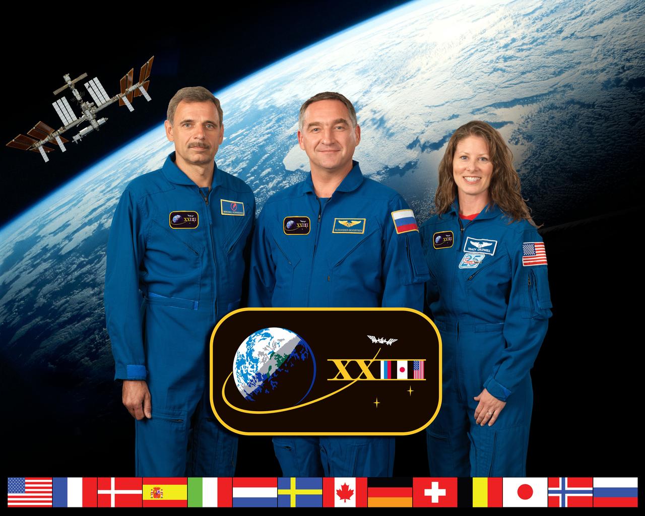 ISS023-S-002C (7 July 2009) --- Russian cosmonauts Mikhail Kornienko (left) and Alexander Skvortsov; along with NASA astronaut Tracy Caldwell Dyson, all Expedition 23 flight engineers, take a break from training at NASA's Johnson Space Center to pose for a portrait.