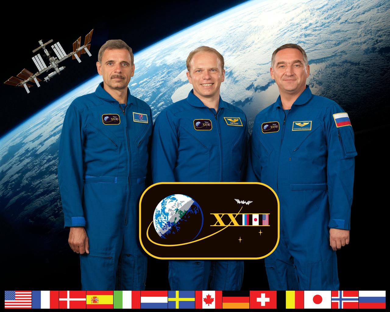 ISS023-S-002D (7 July 2009) --- Russian cosmonaut Oleg Kotov (center), Expedition 23 commander; along with cosmonauts Mikhail Kornienko (left) and Alexander Skvortsov, both flight engineers, take a break from training at NASA's Johnson Space Center to pose for a portrait.