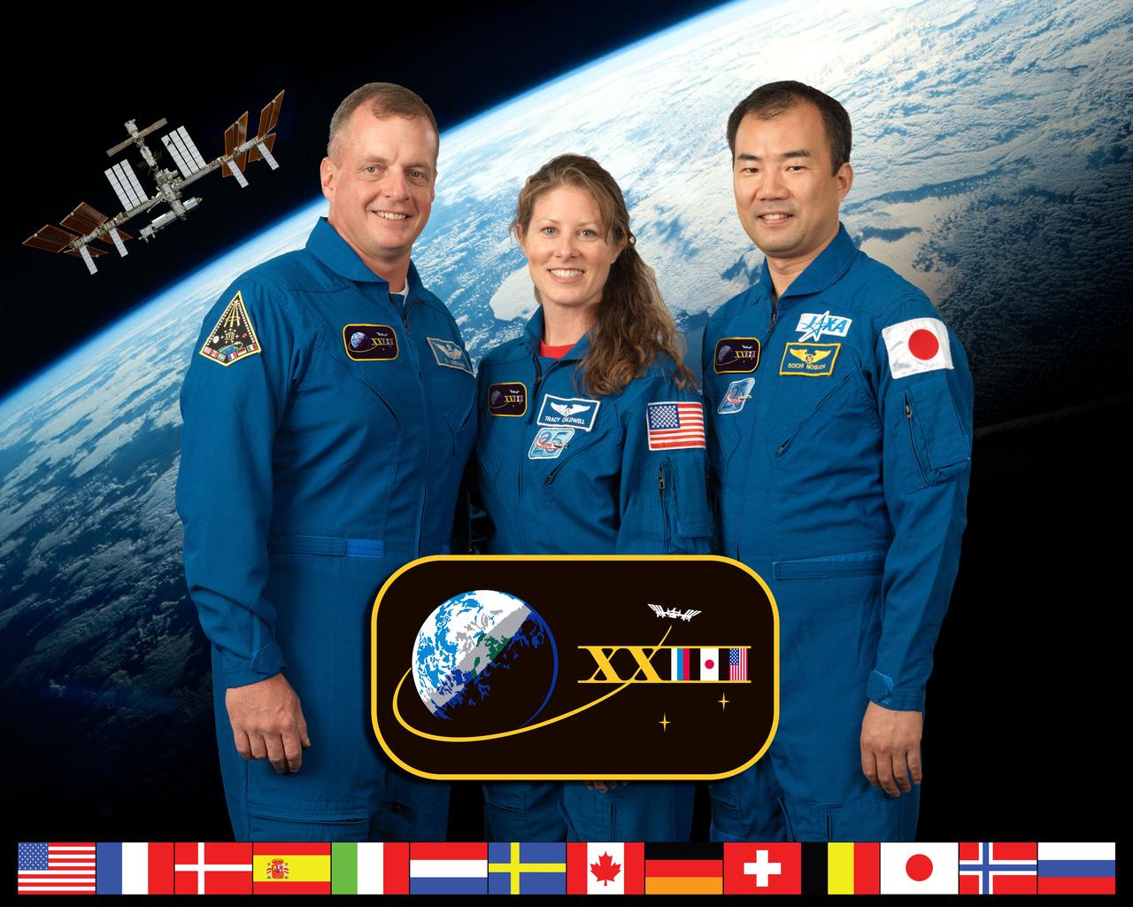 ISS023-S-002E (7 July 2009) --- NASA astronauts T.J. Creamer (left) and Tracy Caldwell Dyson, both Expedition 23 flight engineers; along with Japan Aerospace Exploration Agency (JAXA) astronaut Soichi Noguchi, flight engineer, take a break from training at NASA's Johnson Space Center to pose for a portrait.