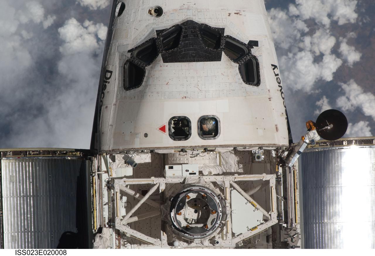 ISS023-E-020008 (7 April 2010) --- This view of the crew cabin and part of the cargo bay of the space shuttle Discovery was provided by an Expedition 23 crew member during a survey of the approaching vehicle prior to docking with to the International Space Station. As part of the survey and part of every mission's activities, the STS-131 Discovery crew performed a back-flip for the rendezvous pitch maneuver (RPM). The image was photographed with a digital still camera, using a 400mm lens at a distance of about 600 feet (180 meters).