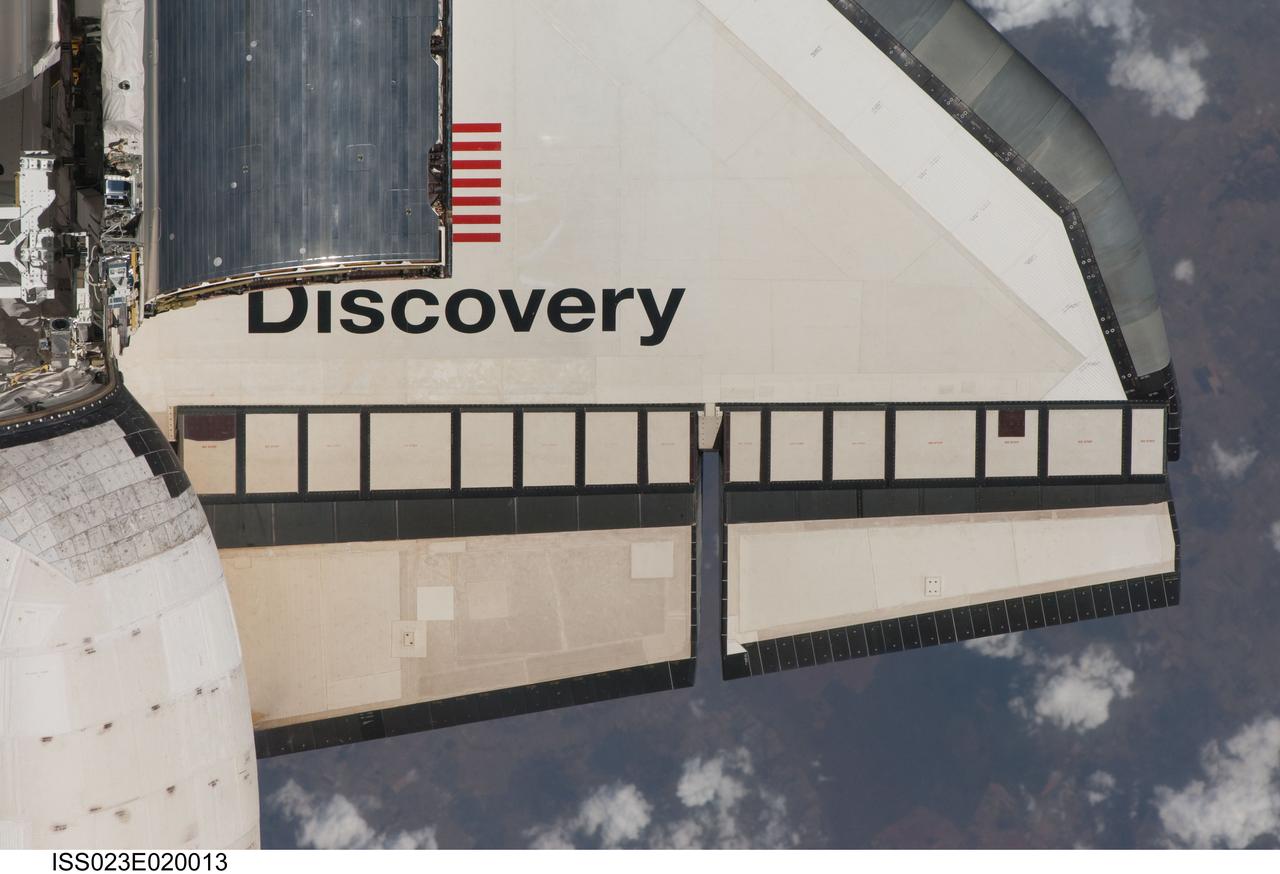 ISS023-E-020013 (7 April 2010) --- This partial view of the starboard wing of the space shuttle Discovery was provided by an Expedition 23 crew member during a survey of the approaching STS-131 vehicle prior to docking with the International Space Station. As part of the survey and part of every mission's activities, Discovery performed a back-flip for the rendezvous pitch maneuver (RPM). The image was photographed with a digital still camera, using a 400mm lens at a distance of about 600 feet (180 meters).