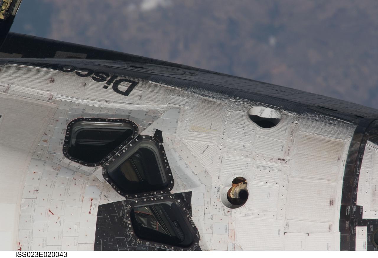 ISS023-E-020043 (7 April 2010) --- This nadir, 800mm view of the portside top part of Discovery's cabin was provided by one of the Expedition 23 crew members onboard the International Space Station.  The shuttle was in the midst of a back-flip, performed to enable the station's cameras to survey it for possible damage. The rendezvous and subsequent docking occurred early on April 7. Once the Discovery crew joins the Expedition 23 crew aboard the orbital complex, nine men and four women will begin several days of joint activities, including three spacewalks.
