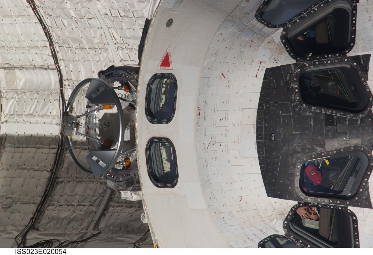 ISS023-E-020054 (7 April 2010) --- This front-on, 800mm view of the top part of Discovery's cabin was provided by one of the Expedition 23 crew members onboard the International Space Station.  The shuttle was in the midst of a back-flip, performed to enable the station's cameras to survey it for possible damage. The rendezvous and subsequent docking occurred early on April 7. Once the Discovery crew joins the Expedition 23 crew aboard the orbital complex, nine men and four women will begin several days of joint activities, including three spacewalks.