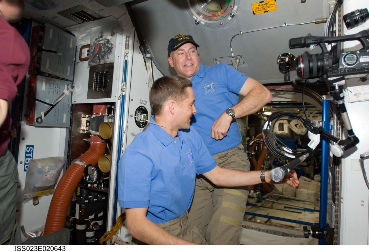 ISS023-E-020643 (7 April 2010) --- NASA astronauts James P. Dutton Jr. (left) and Alan Poindexter, STS-131 pilot and commander, respectively, have just arrived aboard the International Space Station shortly after the Discovery docked with the orbital outpost.  Eleven other astronauts and cosmonauts are not far out of frame, as they look forward to a variety of joint activities over the next several days in Earth orbit.