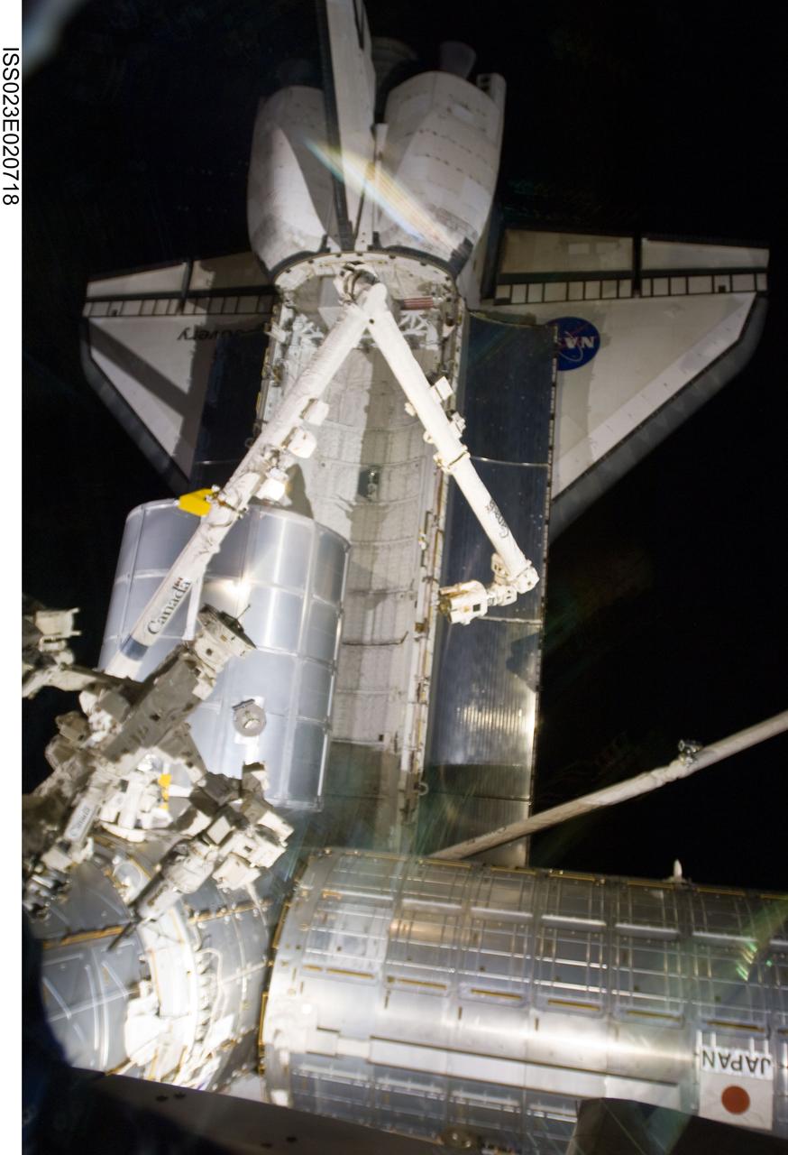 ISS023-E-020718 (8 April 2010) --- The station’s robotic Canadarm2 relocates the Leonardo Multi-purpose Logistics Module (MPLM) from space shuttle Discovery’s payload bay to a port on the Harmony node of the International Space Station.