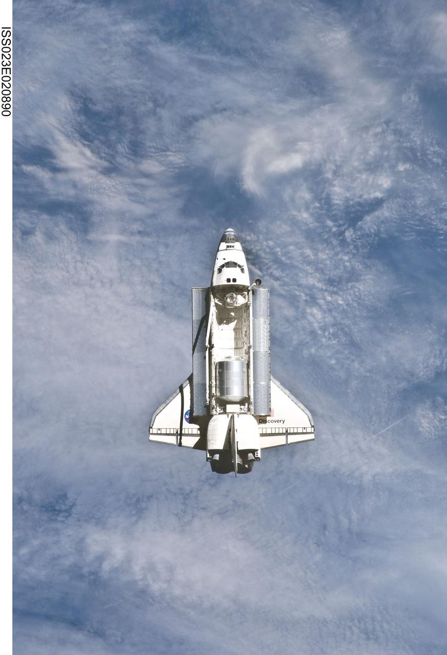 ISS023-E-020890 (7 April 2010) --- The space shuttle Discovery and the International Space Station (out of frame) are in the midst of their rendezvous and docking activities in this image photographed by an Expedition 23 crew member aboard the orbital outpost.