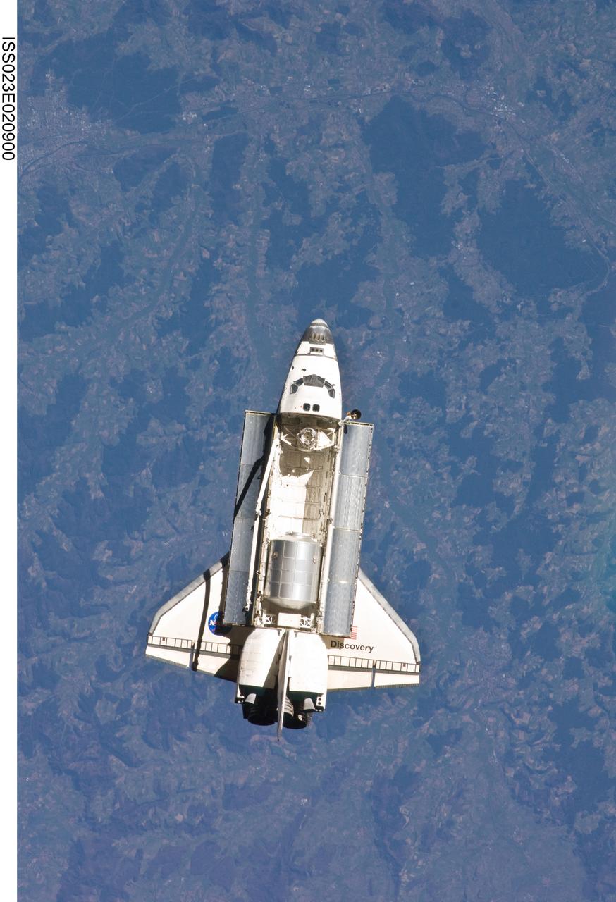 ISS023-E-020900 (7 April 2010) --- The space shuttle Discovery and the International Space Station (out of frame) are in the midst of their rendezvous and docking activities in this image photographed by an Expedition 23 crew member aboard the orbital outpost.