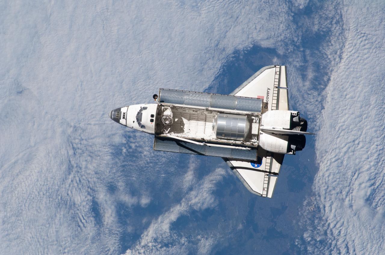 ISS023-E-020909 (7 April 2010) --- The space shuttle Discovery and the International Space Station (out of frame) are in the midst of their rendezvous and docking activities in this image photographed by an Expedition 23 crew member aboard the orbital outpost.