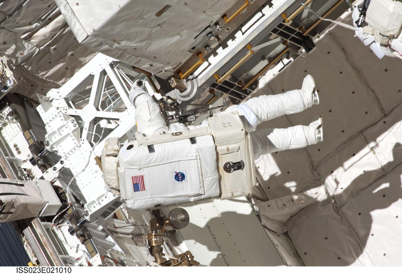 ISS023-E-021010 (9 April 2010) --- NASA astronaut Clayton Anderson, STS-131 mission specialist, participates in the mission's first session of extravehicular activity (EVA) as construction and maintenance continue on the International Space Station. During the six-hour, 27-minute spacewalk, Anderson and astronaut Rick Mastracchio (out of frame), mission specialist, helped move a new 1,700-pound ammonia tank from space shuttle Discovery’s cargo bay to a temporary parking place on the station, retrieved an experiment from the Japanese Kibo Laboratory exposed facility and replaced a Rate Gyro Assembly on one of the truss segments.