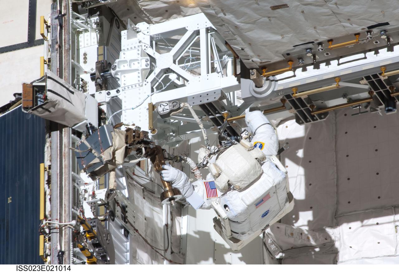 ISS023-E-021014 (9 April 2010) --- NASA astronaut Clayton Anderson, STS-131 mission specialist, participates in the mission's first session of extravehicular activity (EVA) as construction and maintenance continue on the International Space Station. During the six-hour, 27-minute spacewalk, Anderson and astronaut Rick Mastracchio (out of frame), mission specialist, helped move a new 1,700-pound ammonia tank from space shuttle Discovery’s cargo bay to a temporary parking place on the station, retrieved an experiment from the Japanese Kibo Laboratory exposed facility and replaced a Rate Gyro Assembly on one of the truss segments.