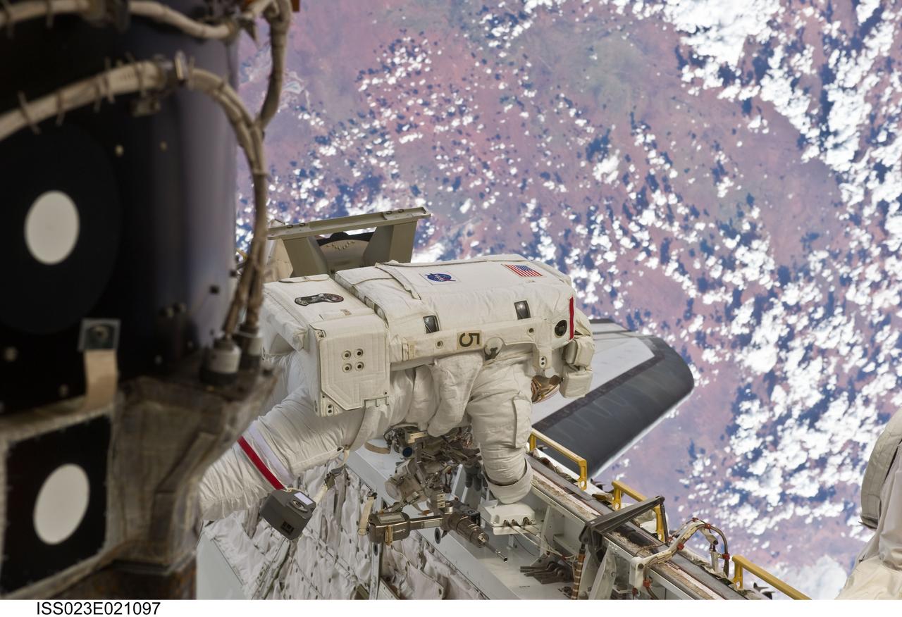 ISS023-E-021097 (9 April 2010) --- NASA astronaut Rick Mastracchio, STS-131 mission specialist, participates in the mission's first session of extravehicular activity (EVA) as construction and maintenance continue on the International Space Station. During the six-hour, 27-minute spacewalk, Mastracchio and astronaut Clayton Anderson (out of frame), mission specialist, helped move a new 1,700-pound ammonia tank from space shuttle Discovery’s cargo bay to a temporary parking place on the station, retrieved an experiment from the Japanese Kibo Laboratory exposed facility and replaced a Rate Gyro Assembly on one of the truss segments.