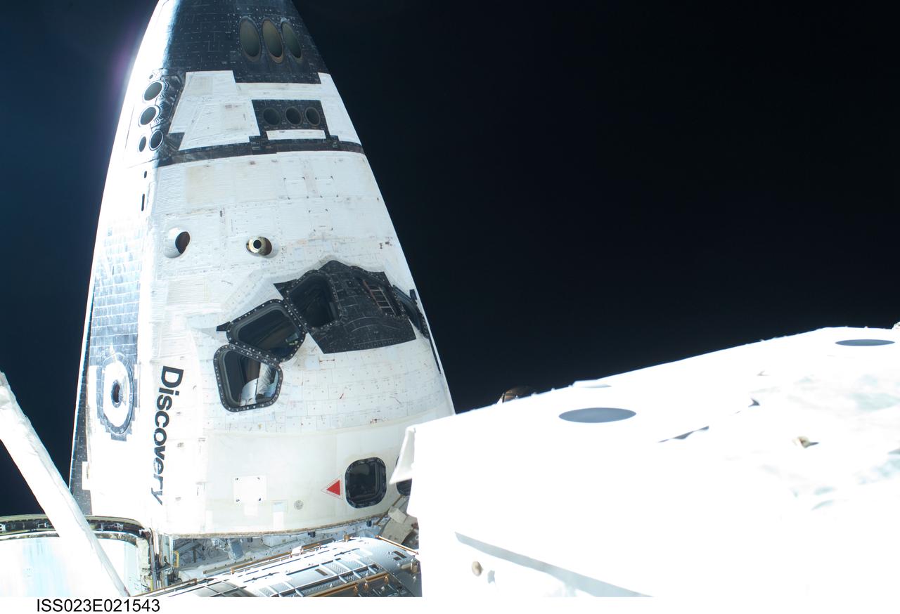 ISS023-E-021543 (11 April 2010) --- The nose and forward cabin of the docked space shuttle Discovery is featured in this image photographed by a spacewalker during the STS-131 mission's second session of extravehicular activity (EVA) as construction and maintenance continue on the International Space Station.