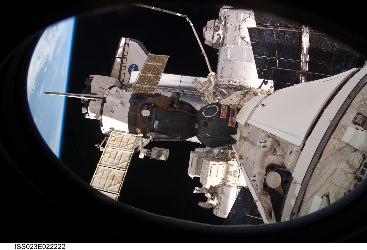 ISS023-E-022222 (13 April 2010) --- Dwarfed by components of the International Space Station, NASA astronaut Rick Mastracchio (bottom center), STS-131 mission specialist, is seen working near the Quest airlock during the mission's third and final session of extravehicular activity (EVA) as construction and maintenance continue on the orbital complex. During the six-hour, 24-minute spacewalk, Mastracchio and astronaut Clayton Anderson (out of frame), mission specialist, hooked up fluid lines of the new 1,700-pound tank, retrieved some micrometeoroid shields from the Quest airlock’s exterior, relocated a portable foot restraint and prepared cables on the Zenith 1 truss for a spare Space to Ground Ku-Band antenna, two chores required before space shuttle Atlantis' STS-132/ULF-4 mission in May. Also featured in the image are a docked Russian Soyuz spacecraft and space shuttle Discovery.