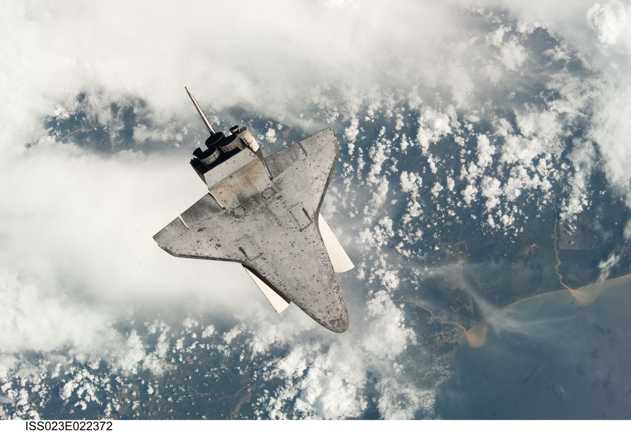 ISS023-E-022372 (7 April 2010) --- The underside of space shuttle Discovery is featured in this image photographed by an Expedition 23 crew member as the shuttle approaches the International Space Station during STS-131 rendezvous and docking operations. Docking occurred at 2:44 a.m. (CDT) on April 7, 2010.