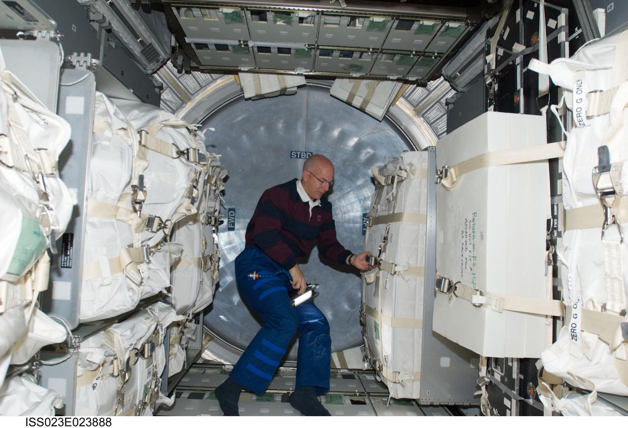 ISS023-E-023888 (15 April 2010) --- NASA astronaut Alan Poindexter, STS-131 commander, works in the Leonardo Multi-purpose Logistics Module (MPLM) linked to the International Space Station while space shuttle Discovery remains docked with the station.