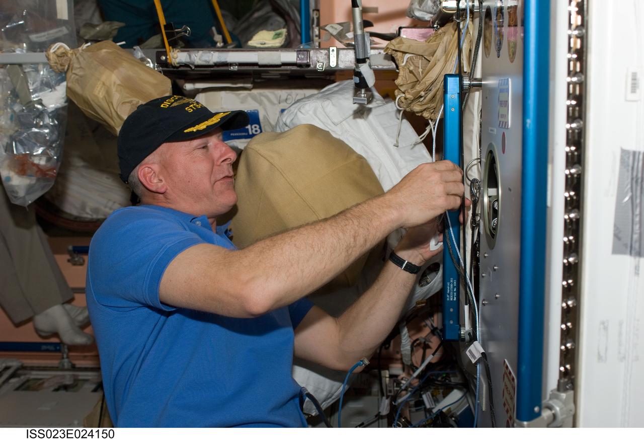 ISS023-E-024150 (16 April 2010) --- NASA astronaut Alan Poindexter, STS-131 commander, adds his crew's patch to the growing collection, in the Unity node, of insignias representing crews who have worked on the International Space Station.