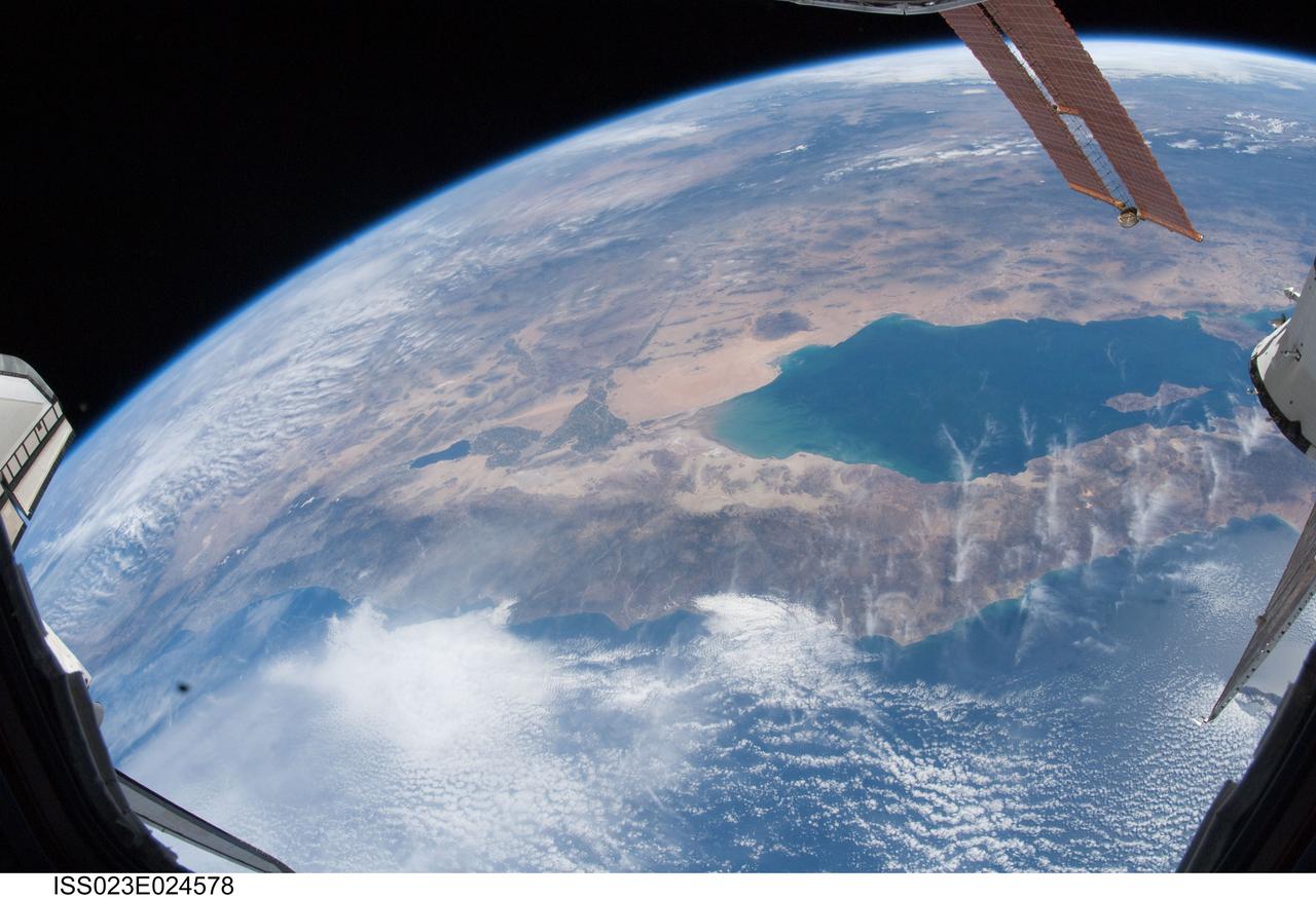 ISS023-E-024578 (15 April 2010) --- The Gulf of California (also known as the Sea of Cortez) and the Salton Sea, share this scene with a tiny part of the space shuttle Discovery (starboard wing at left) and the International Space Station (solar panels, upper right). The two spacecraft have been docked for several days as an aggregation of 13 astronauts and cosmonauts continue work on the orbital outpost. They will undock over the weekend and the shuttle is scheduled to return its crew of seven back home on Earth on April 19.